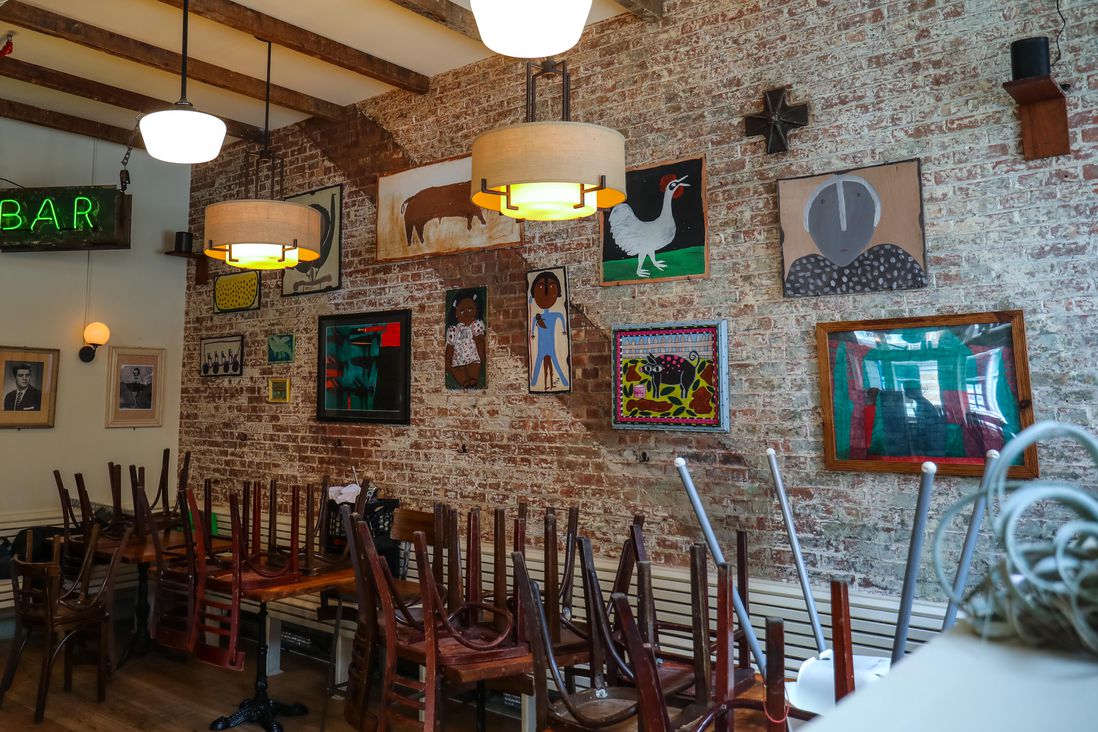 interior of Bubby's, art on walls, chairs on tables